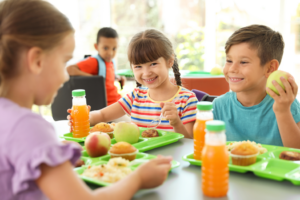 a group of children eating lunch