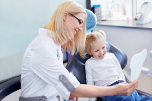 a young child visiting her dentist